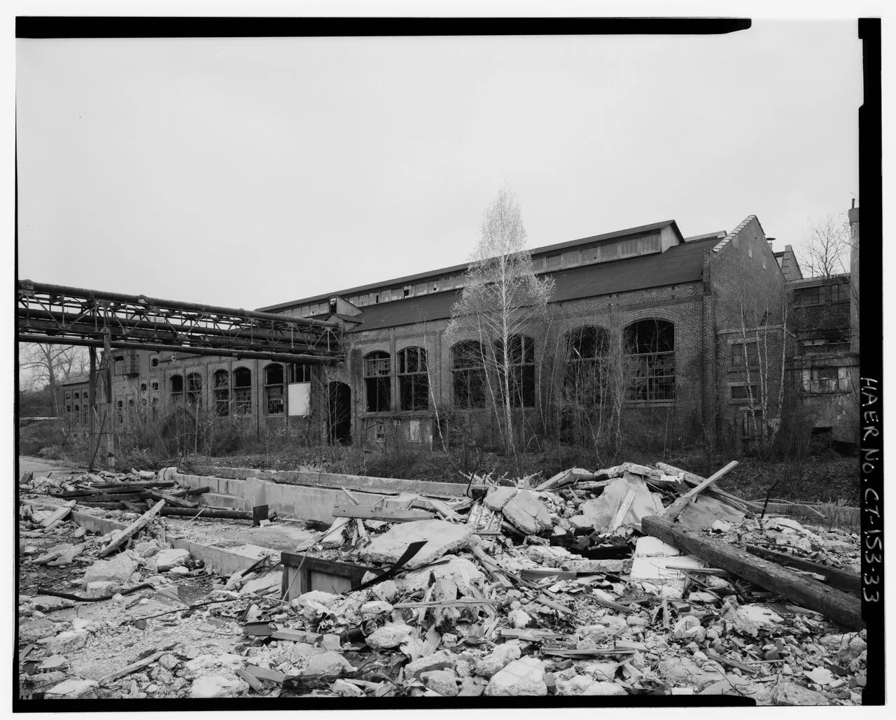 Scovill boiler-plant exterior with debris in foreground. 