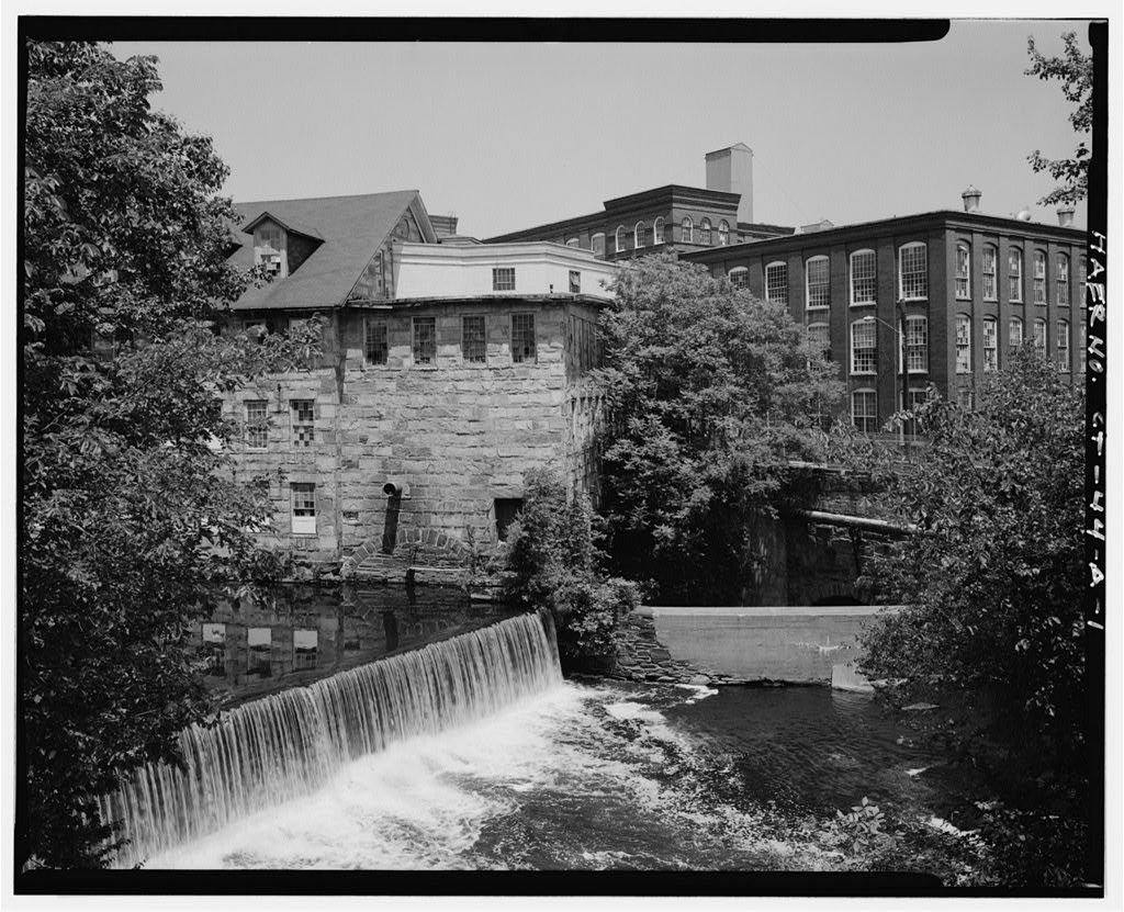 View northeast of wheelhouse area, tailrace (center), and dam; mill no. 5 (haer no. ct-44-b) and bridge at right