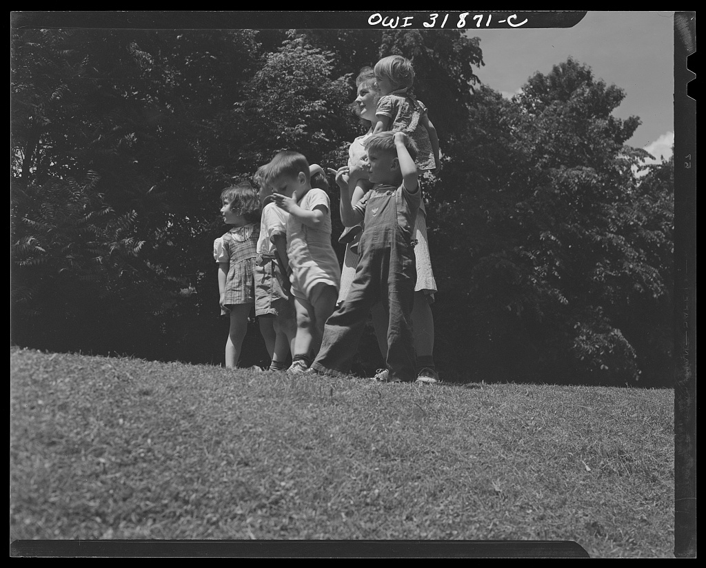 Caregiver and children at a wartime childcare center
