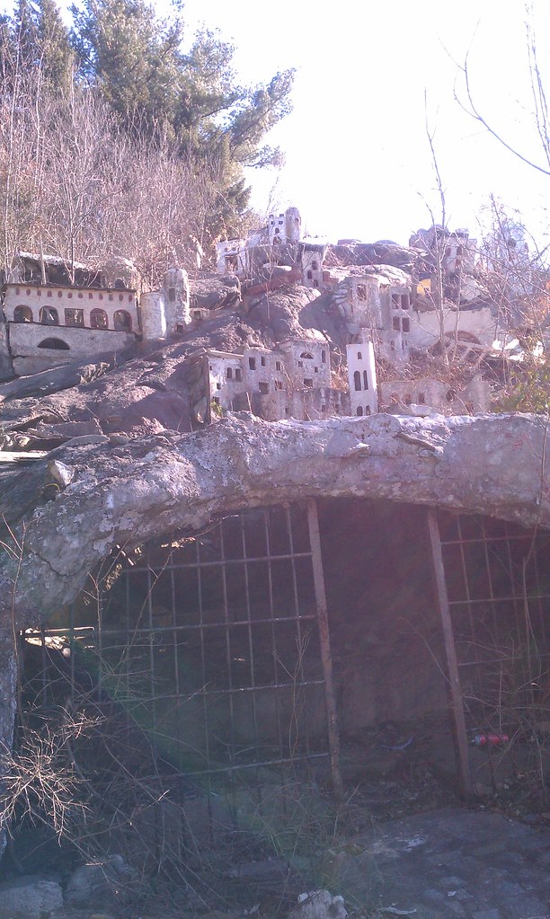 Miniature buildings above a gated opening — 2012
