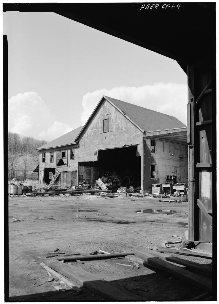 Storehouse and Boathouse as viewed from tunnel under second floor of Pipe, Paint, and Electrical Shop