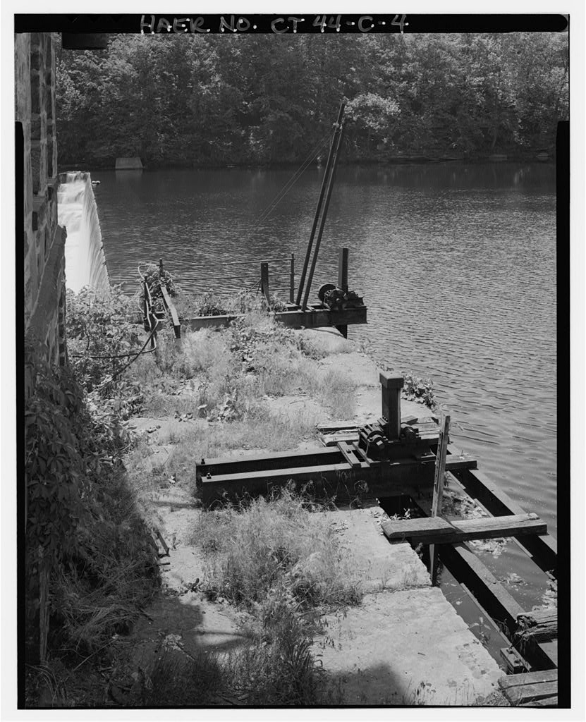 Detail view south of south-most headgate operating mechanism (lower center); draingate operating mechanism at upper…