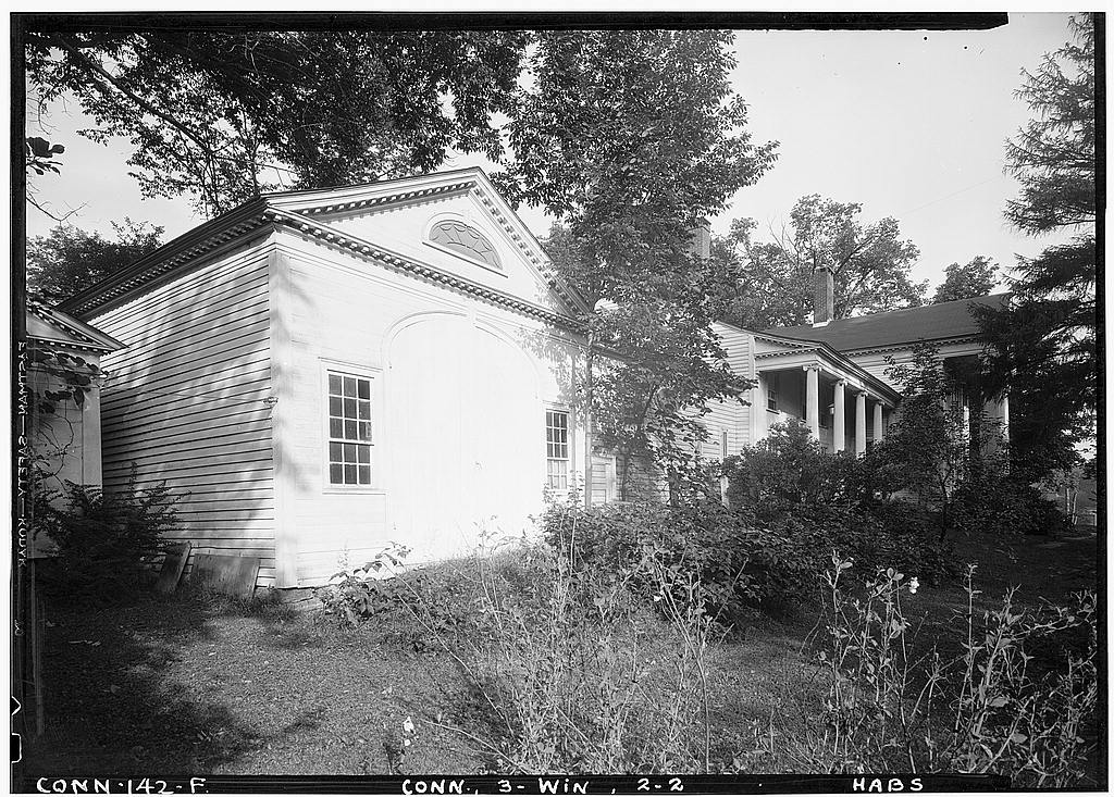 Exterior, general view of entrance (east) front, with coach house in foreground