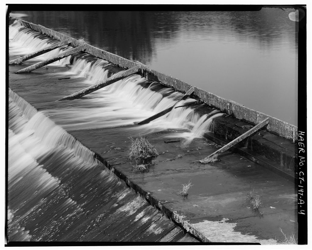 View northwest, detail of stone cap and flashboards at top of dam
