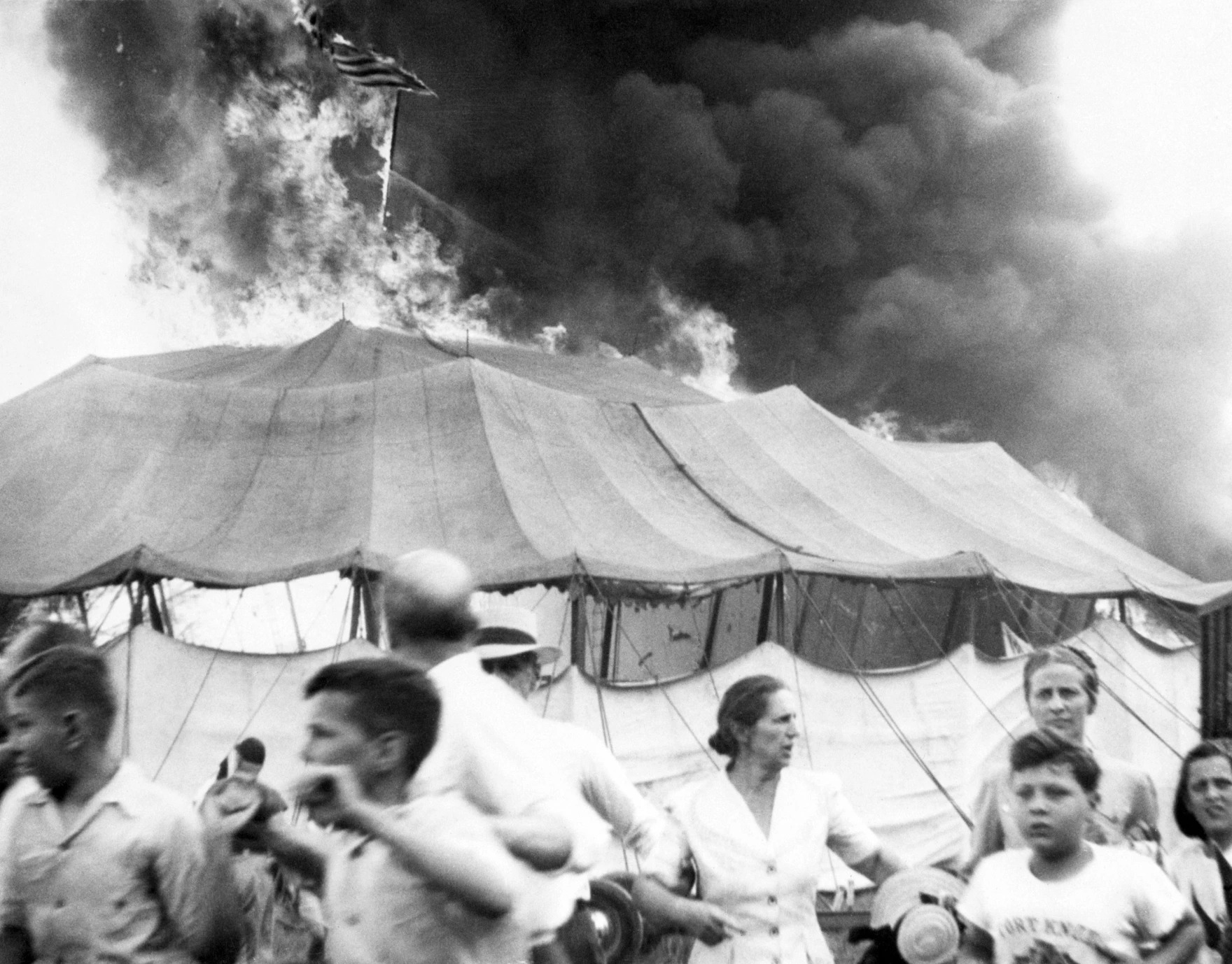 Spectators escaping the burning circus tent